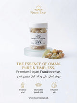A jar of Noor East Premium Hojari Frankincense displayed on a clear acrylic riser with loose frankincense buds beside it, on a clean white background with gold branding and product text.
