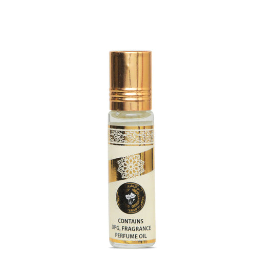 Perfume oil bottle with gold cap and white label on a white background