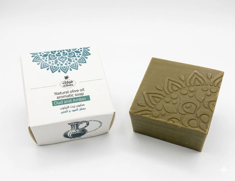 Green soap bar with embossed design next to its packaging on a white background