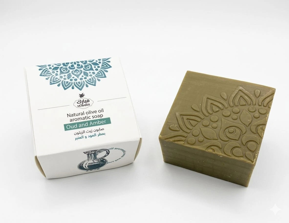 Green soap bar with embossed design next to its packaging on a white background