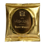 Gold packaging of oudy woody bakhoor with brand logo on a white backgroundOudy Woody Choco Bakhoor 40g – Surrati