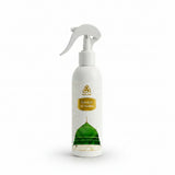 A white spray bottle of WAAW Rawdah Al-Madina fragrance oil, featuring a gold logo and label, and a graphic of a green domed mosque on the lower half.