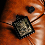 Perfume bottle with intricate design on a brown leather surface