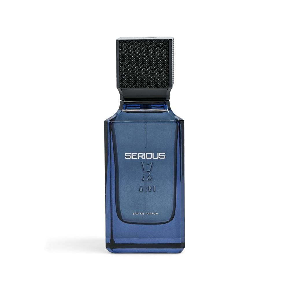 A rectangular blue glass perfume bottle with a black textured cap, featuring the brand name 'SERIOUS' and 'EAU DE PARFUM' printed on the front, set against a plain white background.Serious – Amber Fougère EDP 100ml – Al Majed Oud