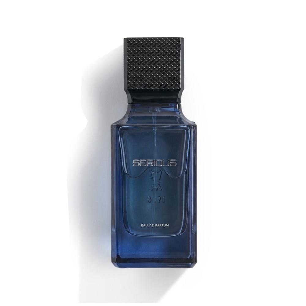A rectangular blue glass perfume bottle with a textured black cap, labeled 'SERIOUS' and 'EAU DE PARFUM', set against a plain white background with a soft shadow.Serious – Amber Fougère EDP 100ml – Al Majed Oud