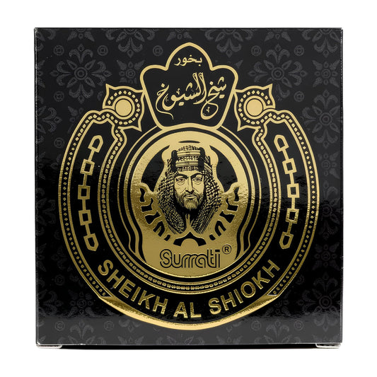 A square black product box with ornate gold foil detailing, featuring a central Sheikh Al Shiaohk emblem and the brand name 'Surrati' printed in gold.Sheikh Al Shiokh Choco Bakhoor 40g – Surrati