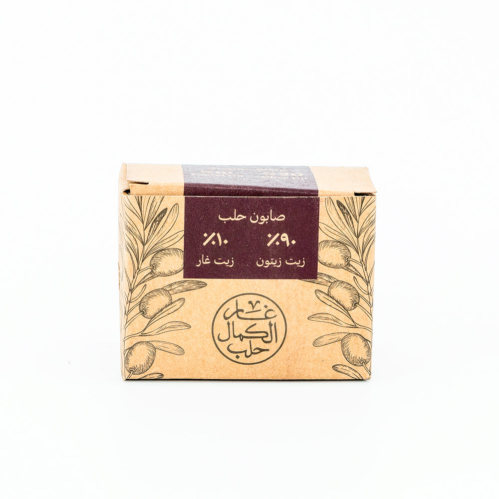 Soap bar with a brown packaging featuring olive tree design and Arabic text on a white background
