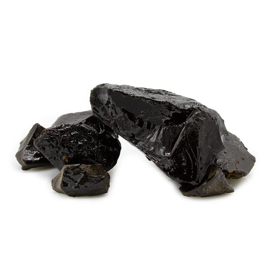 A pile of rough, glossy black volcanic glass fragments or slag pieces on a clean white background.Socotri Sabir (Hadhrami Sabir)صبر حضرمي