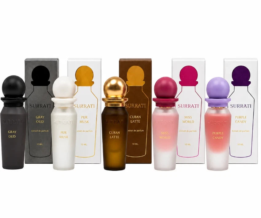 A row of Surratti perfume bottles and matching boxes in assorted colors, including gray, white, gold, brown, pink, and purple, arranged against a plain white background.Surrati Mini Collection 2 -5X10ml EDP-S Gift Set