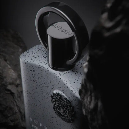 A sleek white speckled afnan supremacy collectors perfume bottle with black cap and silver ring from fragrance houses precious woods