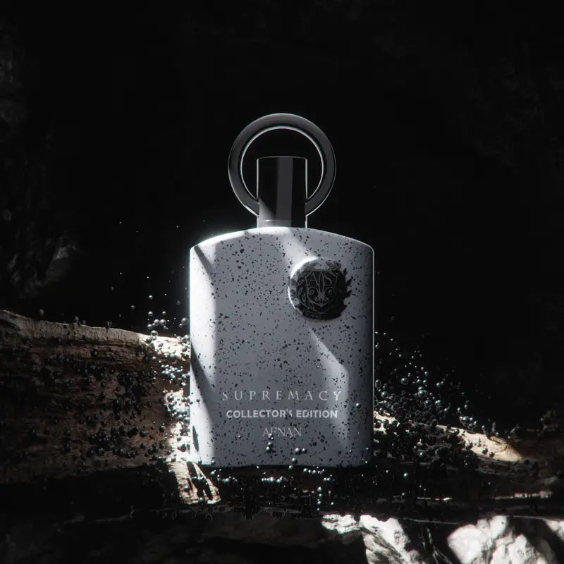 A sleek speckled white afnan supremacy collectors perfume bottle with metallic ring cap and embossed logo for precious woods fragrance houses