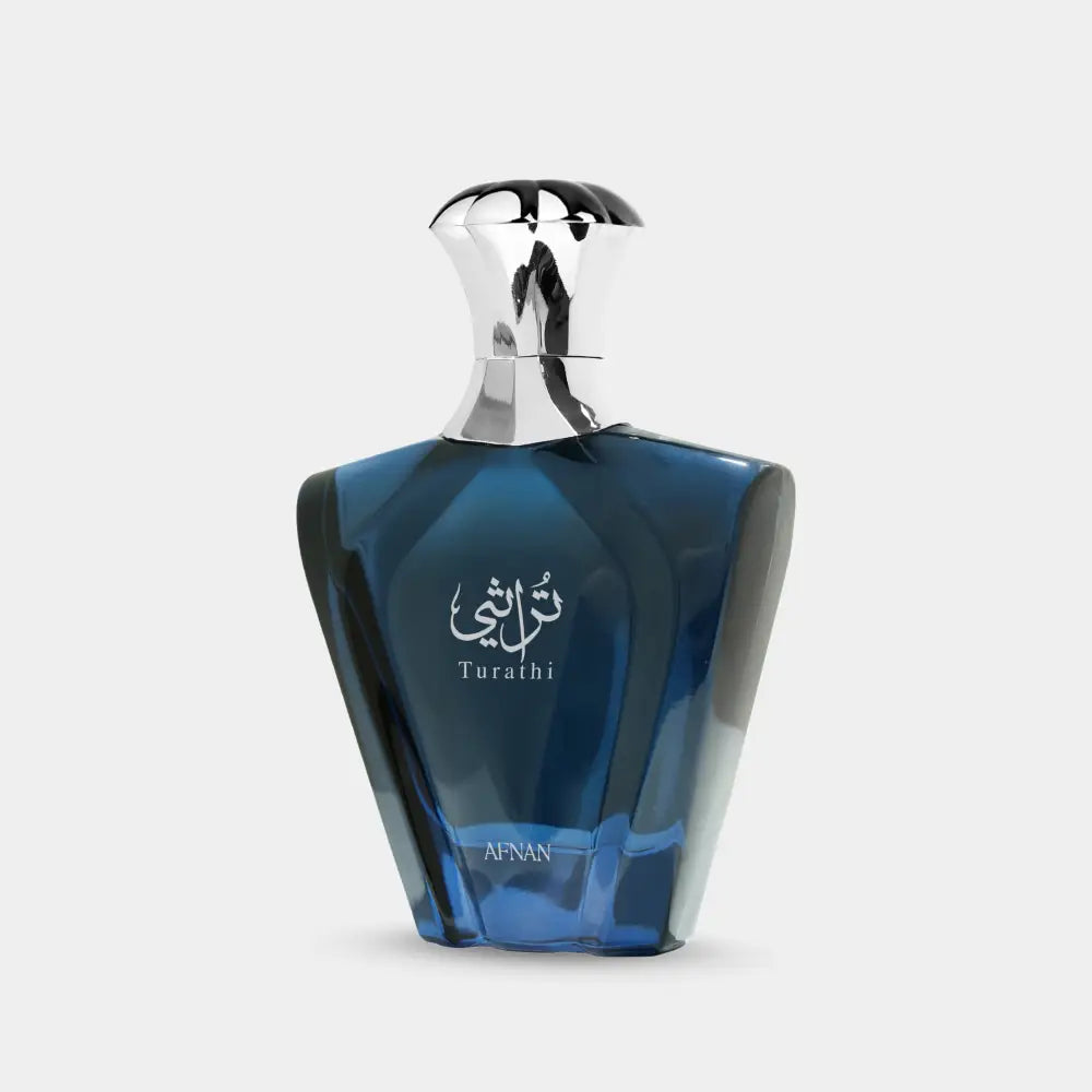 A sleek deep blue glass turathi blue perfume bottle with silver cap and elegant arabic script labeling for men