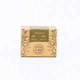 Bar of soap in a cardboard box with olive design on a white background
