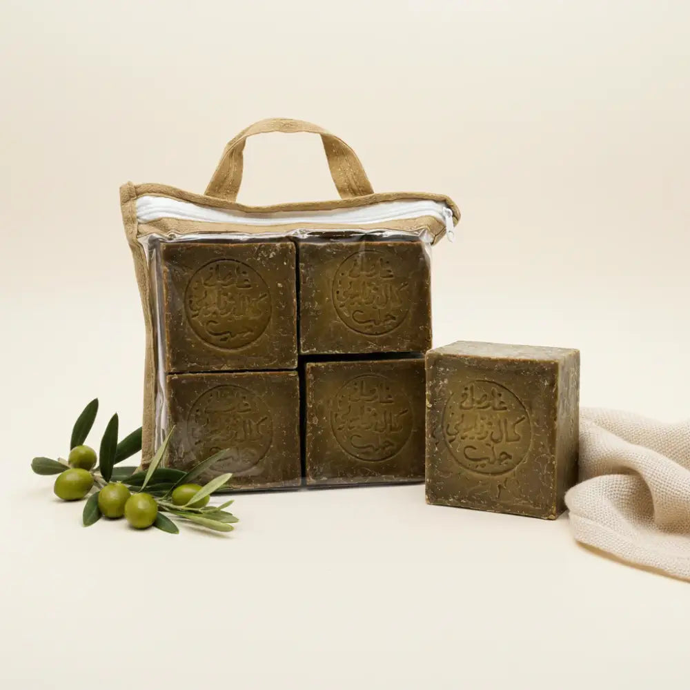 Four bars of brown soap in a clear plastic bag with a handle on a white background.