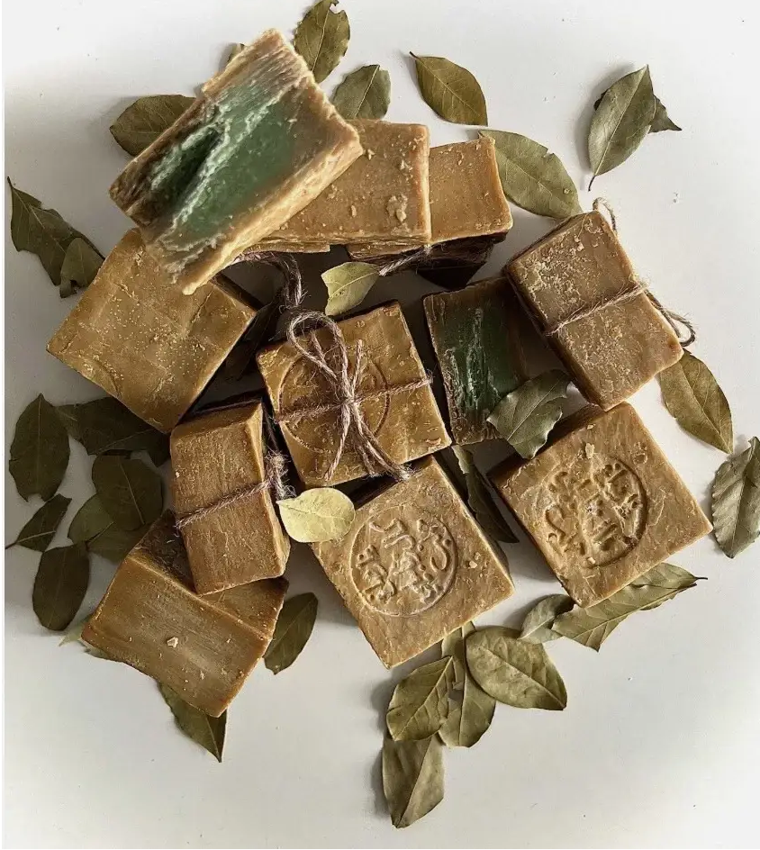 Brown soap bars with green leaves on a white background