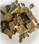 Brown soap bars with green leaves on a white background