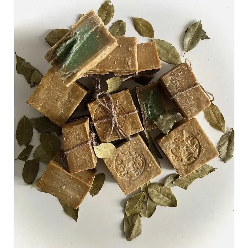 Brown soap bars with green leaves on a white background