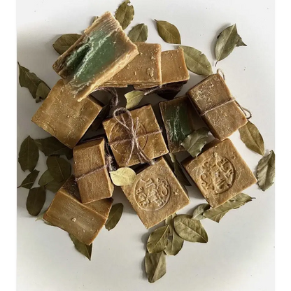 Brown soap bars with green leaves on a white background