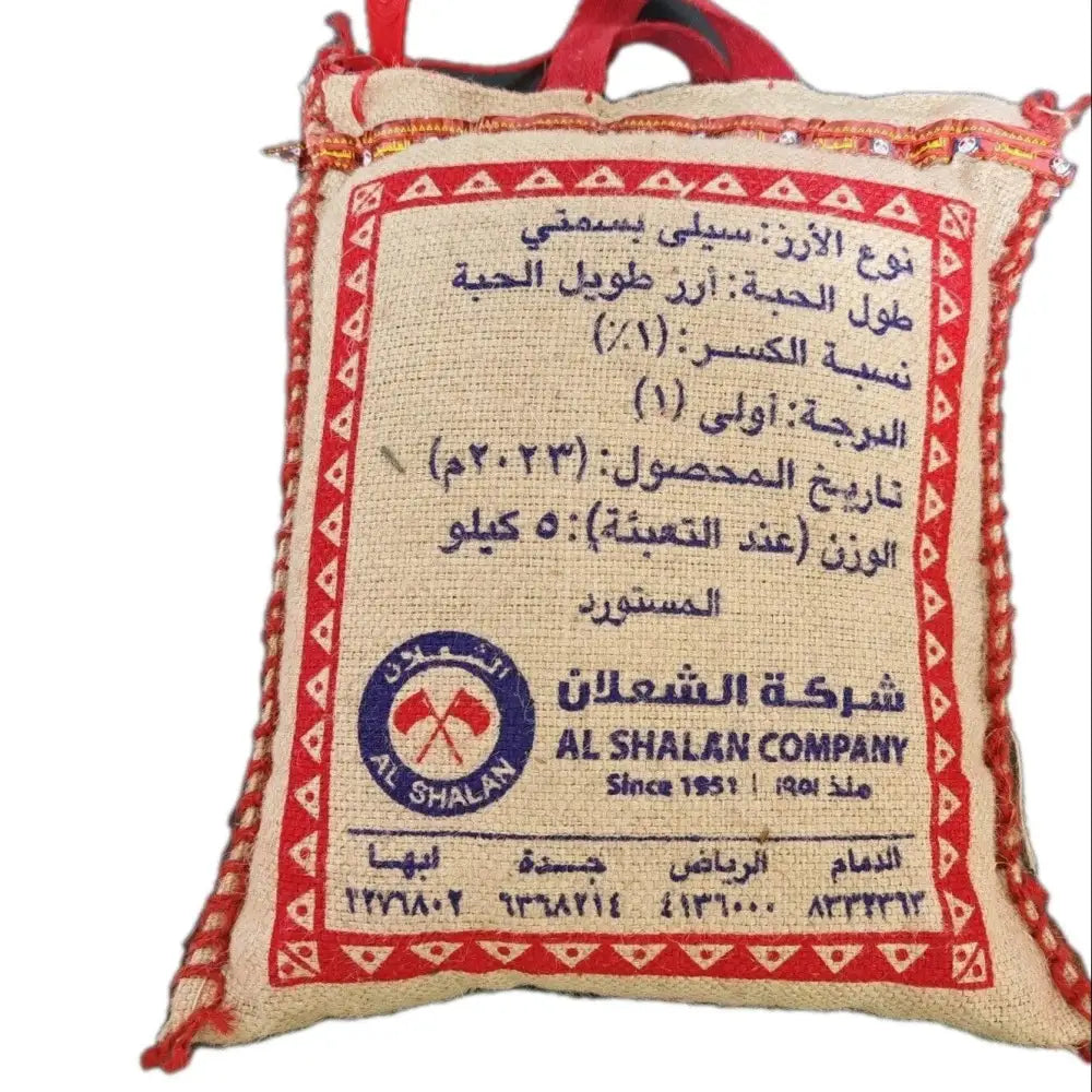 Beige woven sack with red embroidered trim and arabic english text featuring al shalan logo for premium long basmati rice
