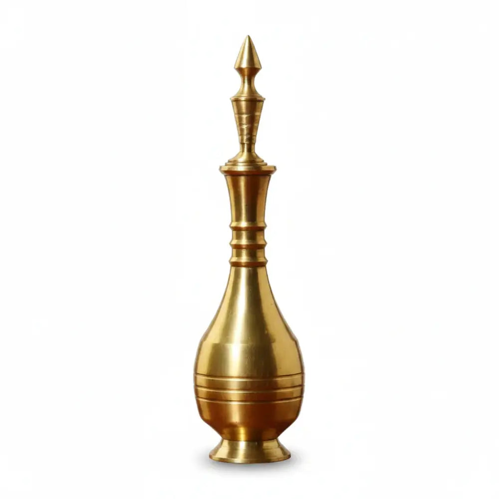 Gold-colored decorative object with a spout on a white background