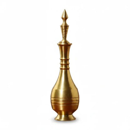 Gold-colored decorative object with a spout on a white background