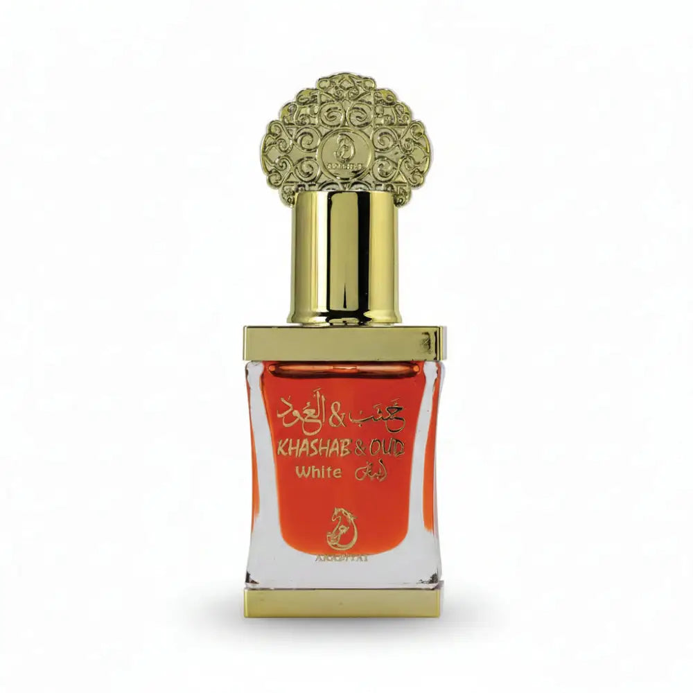 Decorative perfume bottle with gold cap and white label on a black background