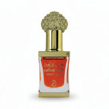 Decorative perfume bottle with gold cap and white label on a black background