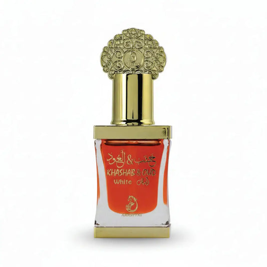 Decorative perfume bottle with gold cap and white label on a black background