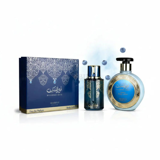 The arabiyat prestige blueberry musk gift set features a blue and gold perfume bottle and lotion dispenser with silver and gold details