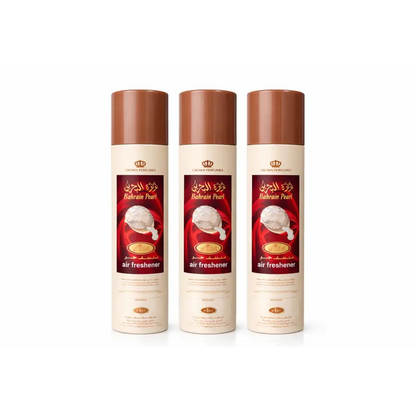 Three identical bahrain pearl air freshener cans with cream body brown caps and red arabic labels by rehab perfumes