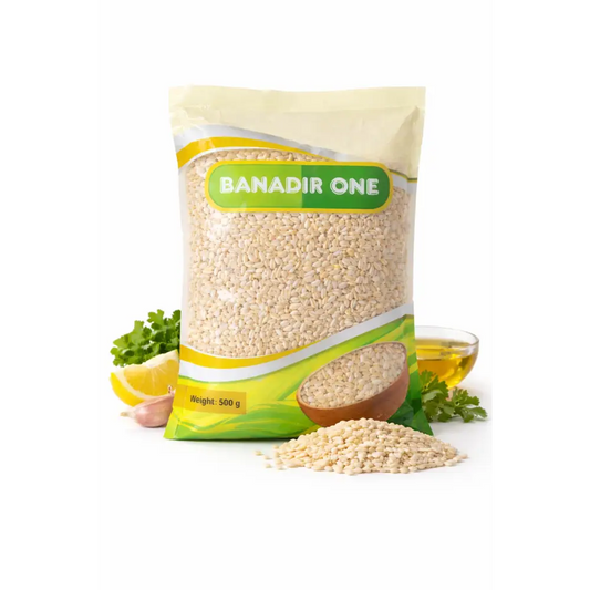 A 500g transparent plastic bag of banadir one premium quality white sesame seeds with a green and yellow label showing seeds in a wooden bowl