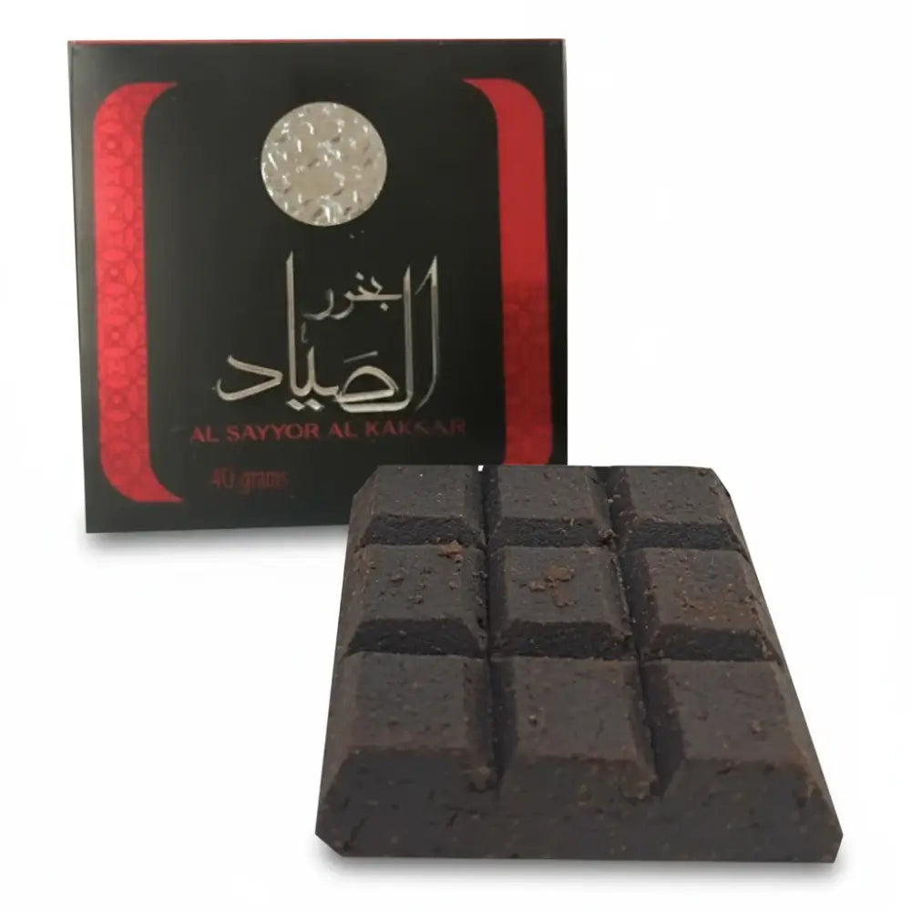 Black soap bars with a branded box on a white background