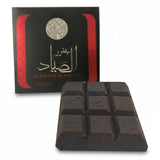 Black soap bars with a branded box on a white background