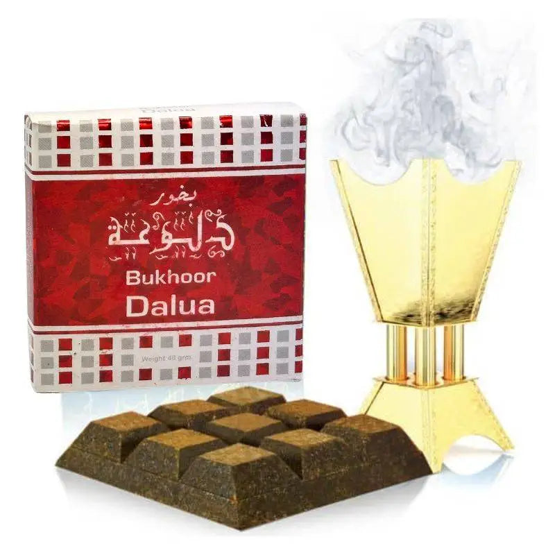 Golden incense burner with smoke rising beside bukhoor dalua 40g box and dark brown incense by ard al zaafaran noor east