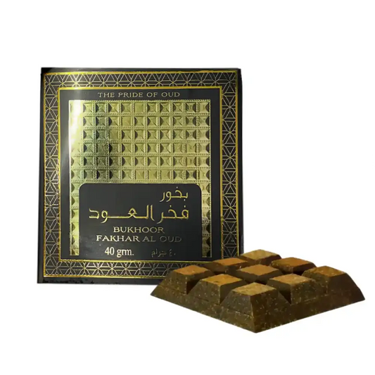 A luxurious dark brown bukhoor fakhar al oud incense stick with ornate black and gold ard al zaafaran packaging 40g
