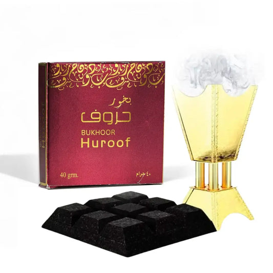 Golden bukhoor huroof incense burner with fluted tiered design and smoke rising from open top by ard al zaafaran noor east