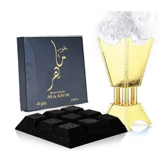 Golden incense burner with intricate vertical ridges and a flared pyramid-shaped top emitting white smoke for bukhoor maahir by ard al zaafaran woody oud