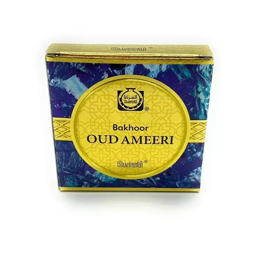 The bukhoor oud ameeri 40g surrati incense box features a vibrant blue and gold design with intricate geometric patterns