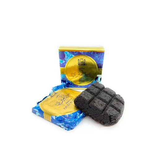 Black rectangular block of charcoal with grid pattern surface of bukhoor oud ameeri 40g by Surrati