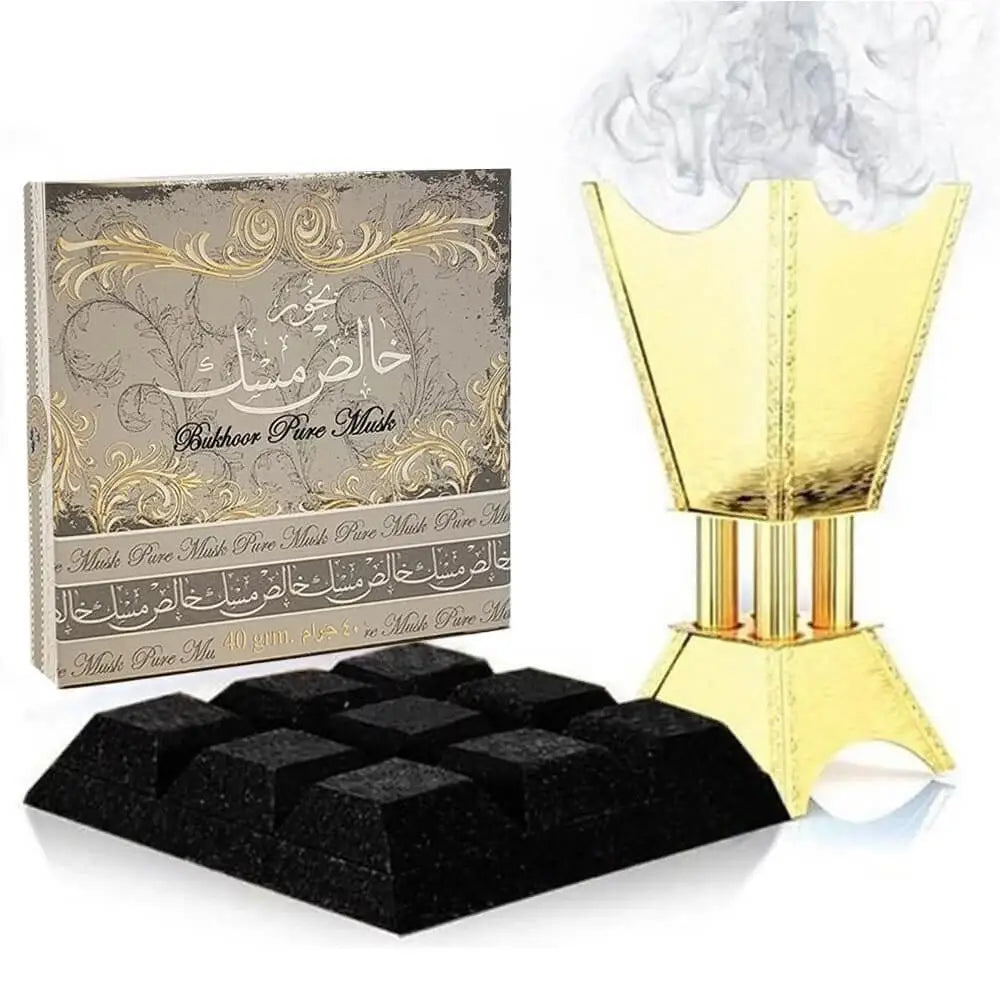Golden incense burner with smoke rising next to bukhoor pure musk box and black aromatic cubes for pure musk fragrance