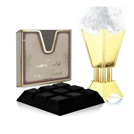 Golden incense burner with intricate detailing and matching turab al dahab box beside black charcoal cubes bukhoor turab ard al zaafaran