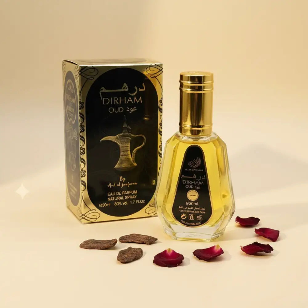 A golden-hued faceted glass bottle of ard al zaafaran dirham oud eau de parfum with arabic script and gold cap