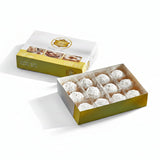 Box of cookies with El Saiedy Patisserie branding on a blue background