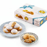 A box of middle eastern egyptian cookies kahk with malban featuring white and blue design with gold accents and ribbon bow