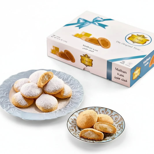 A box of middle eastern egyptian cookies kahk with malban featuring white and blue design with gold accents and ribbon bow