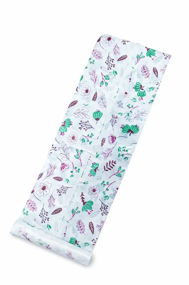 White disposable table sheets sufra roll with green pink and purple floral pattern for food serving and dining area lining