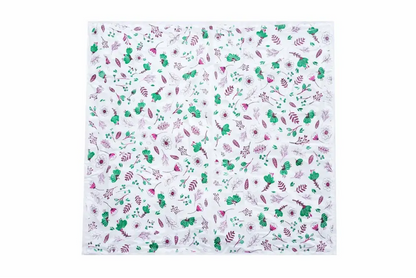 White square scarf with green and pink floral motifs shown with elite disposable table sheets sufra roll for food serving