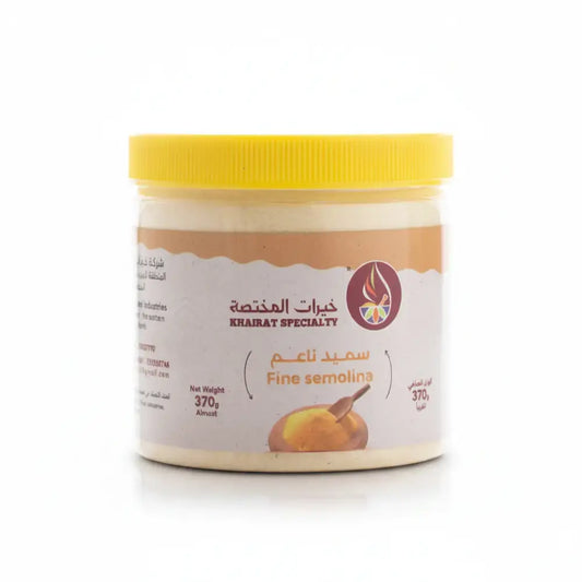 Jar of fine semolina with a yellow lid on a white background