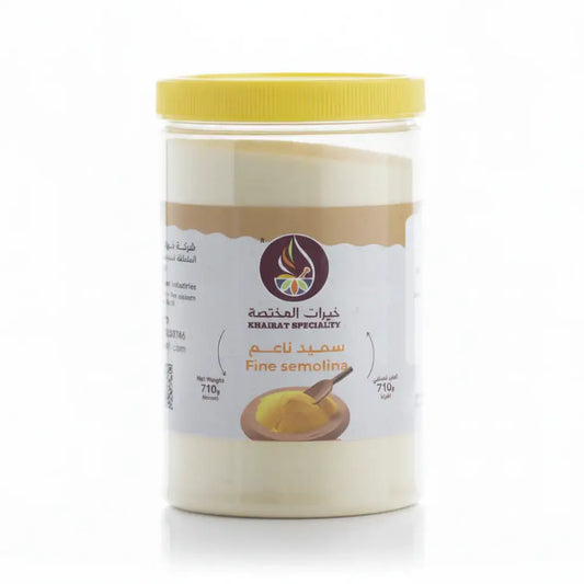 Container of fine semolina with a yellow lid on a white background