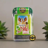 Green and clear plastic container of al helal original mastic with label of two brown hawks on desert for greek chios mastic gum 10g